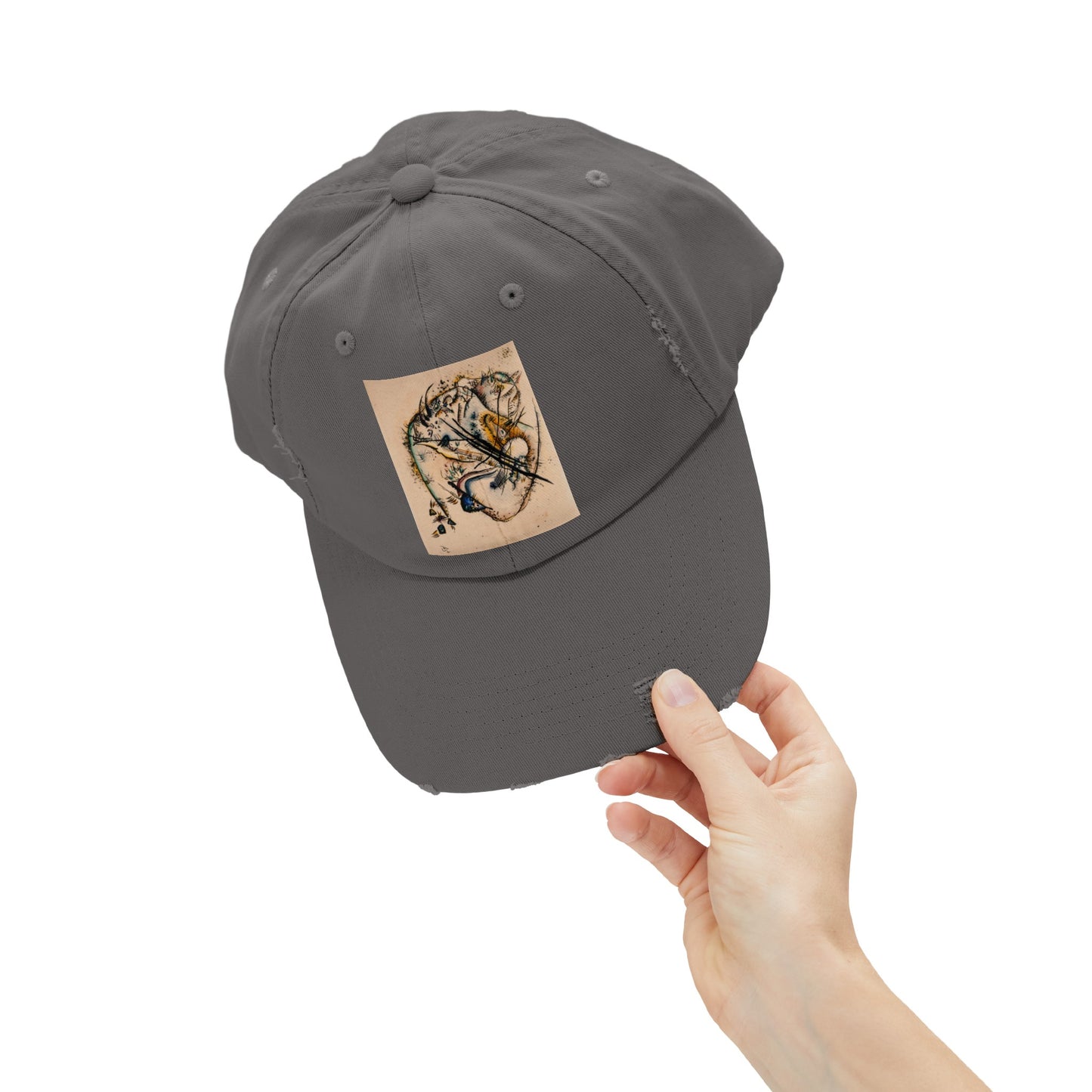 a person holding a gray hat with a sticker on it