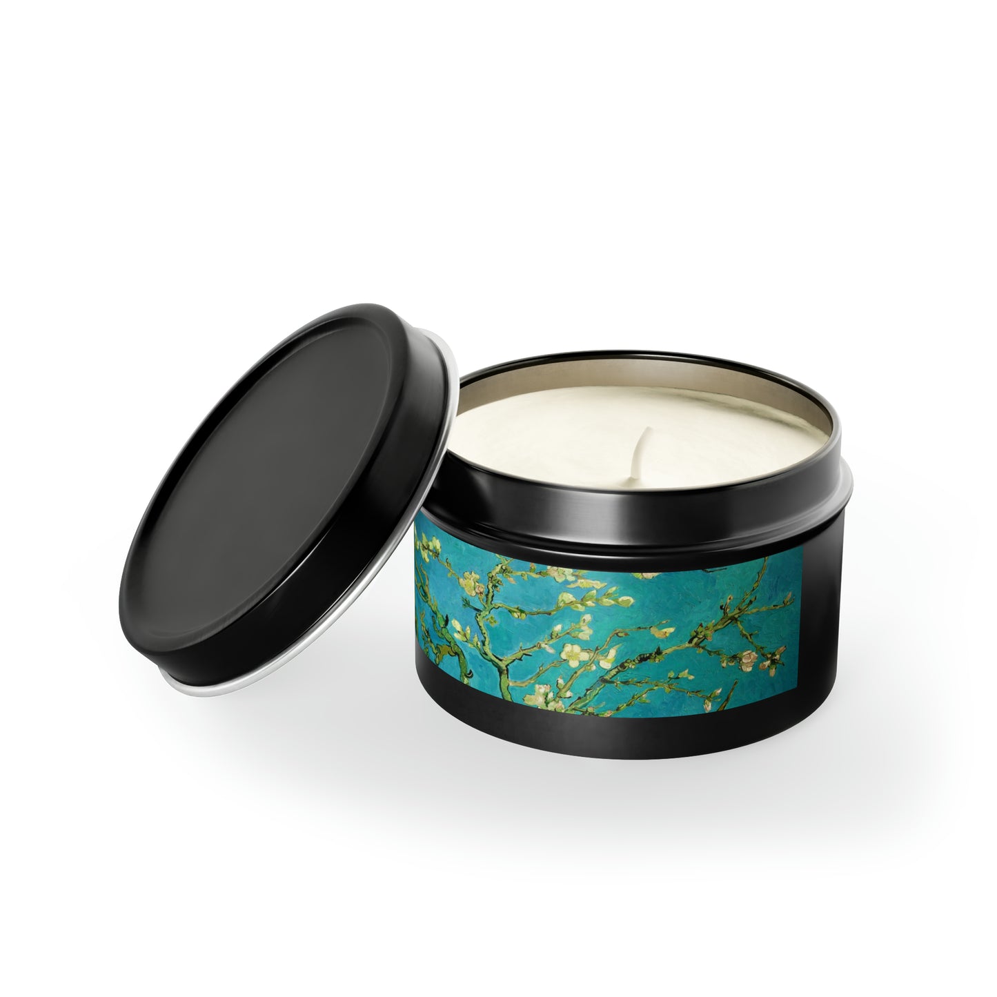 a candle in a black tin with a blue and green design
