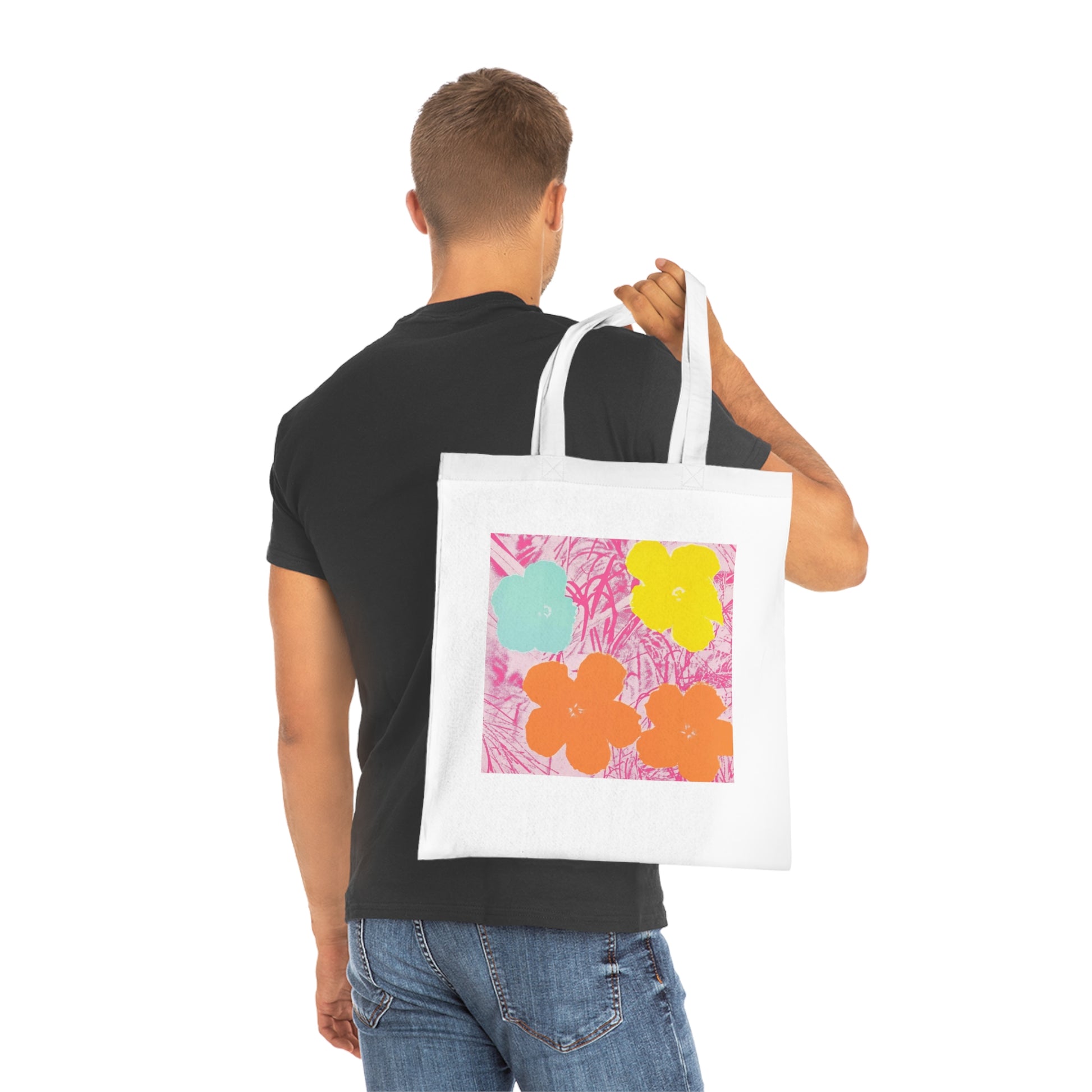 a man holding a white bag with a painting on it