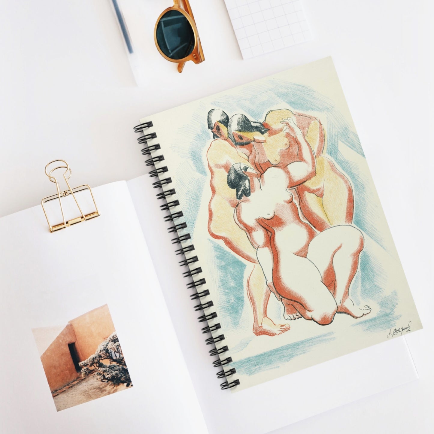 a notebook with a drawing of two nude women