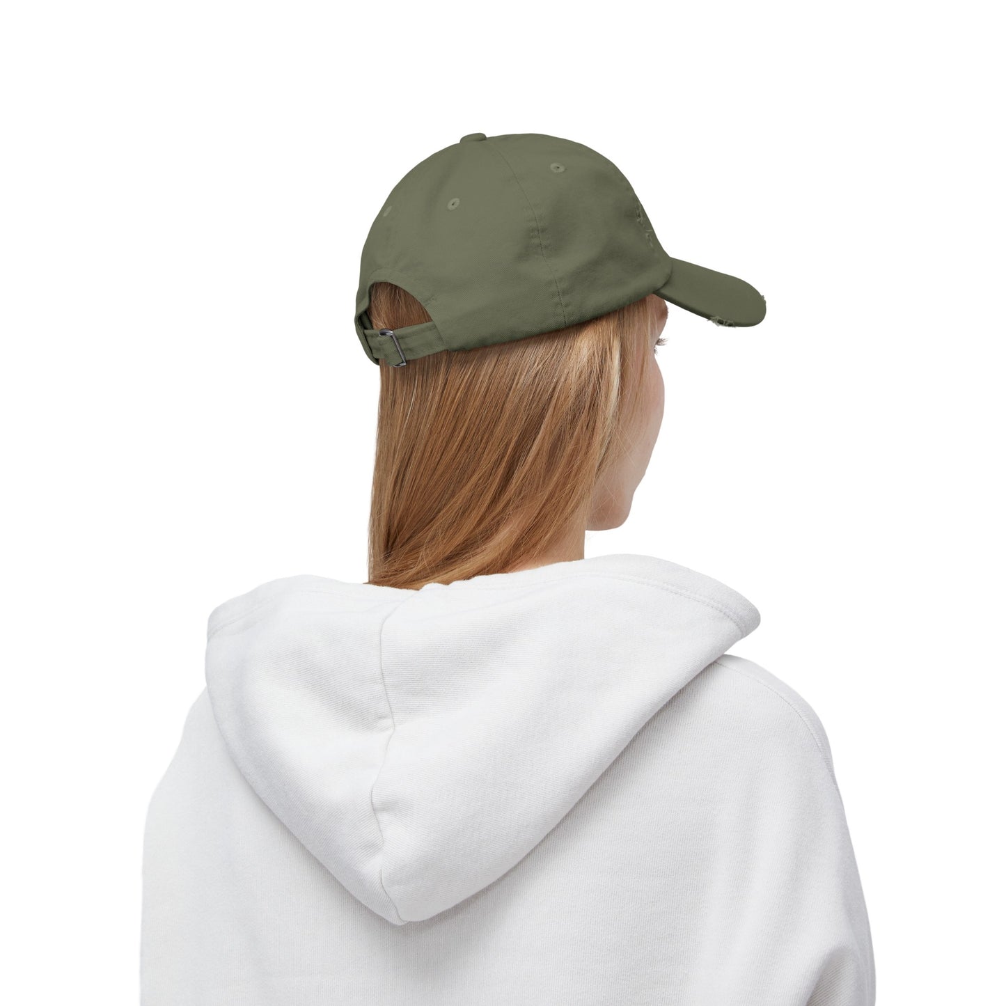 a woman wearing a white hoodie and a green cap