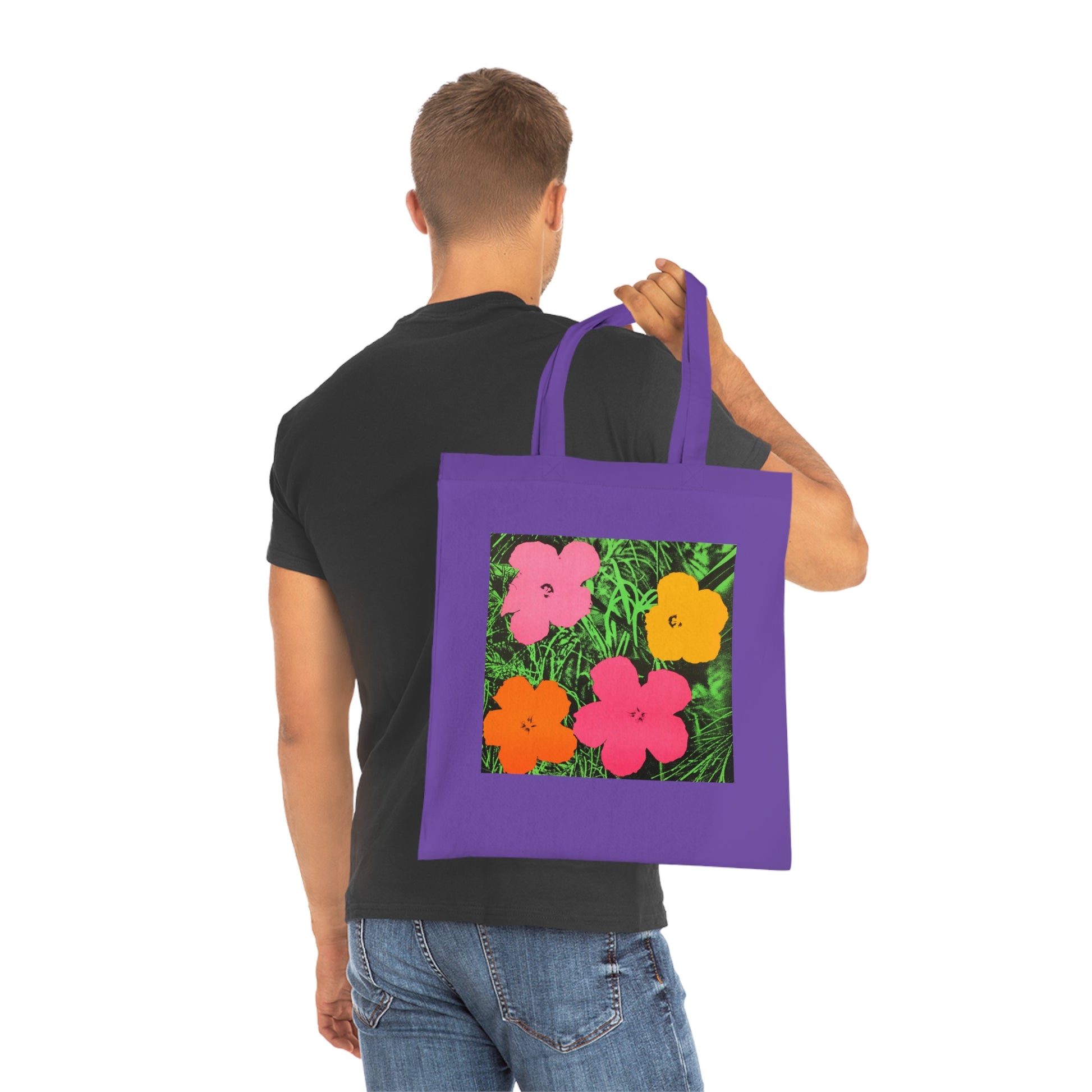 a man carrying a purple tote bag with flowers on it