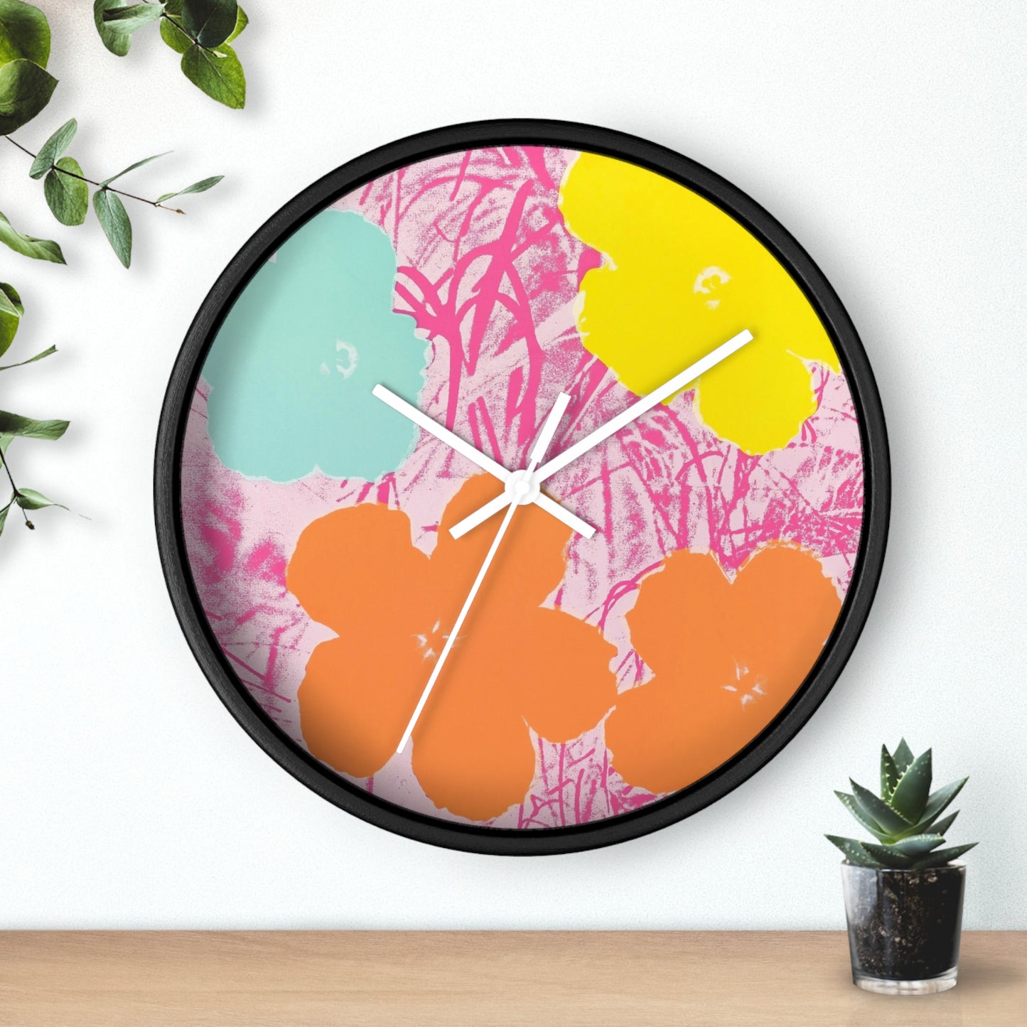 a clock that is on a wall next to a potted plant