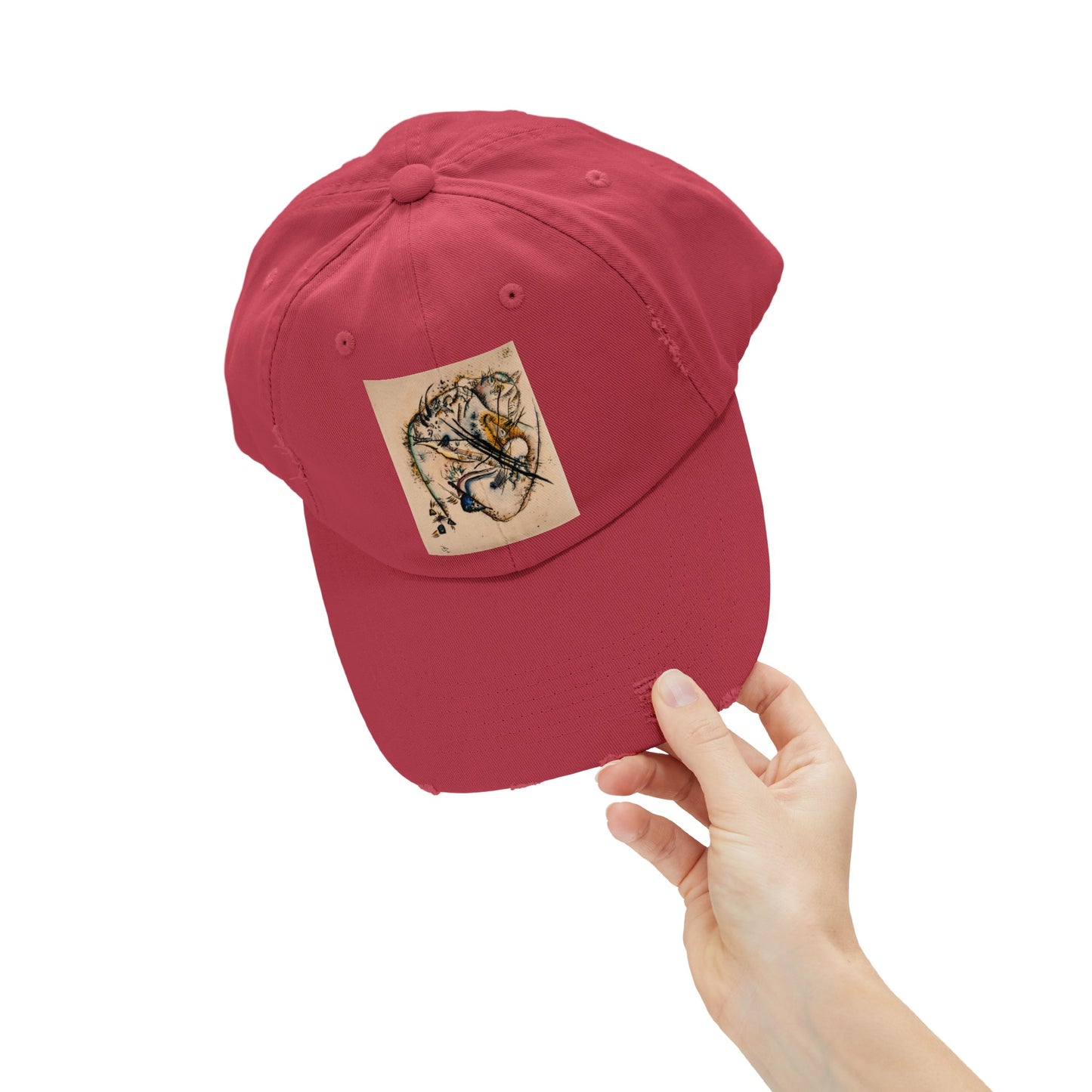 a person holding a red hat with a sticker on it