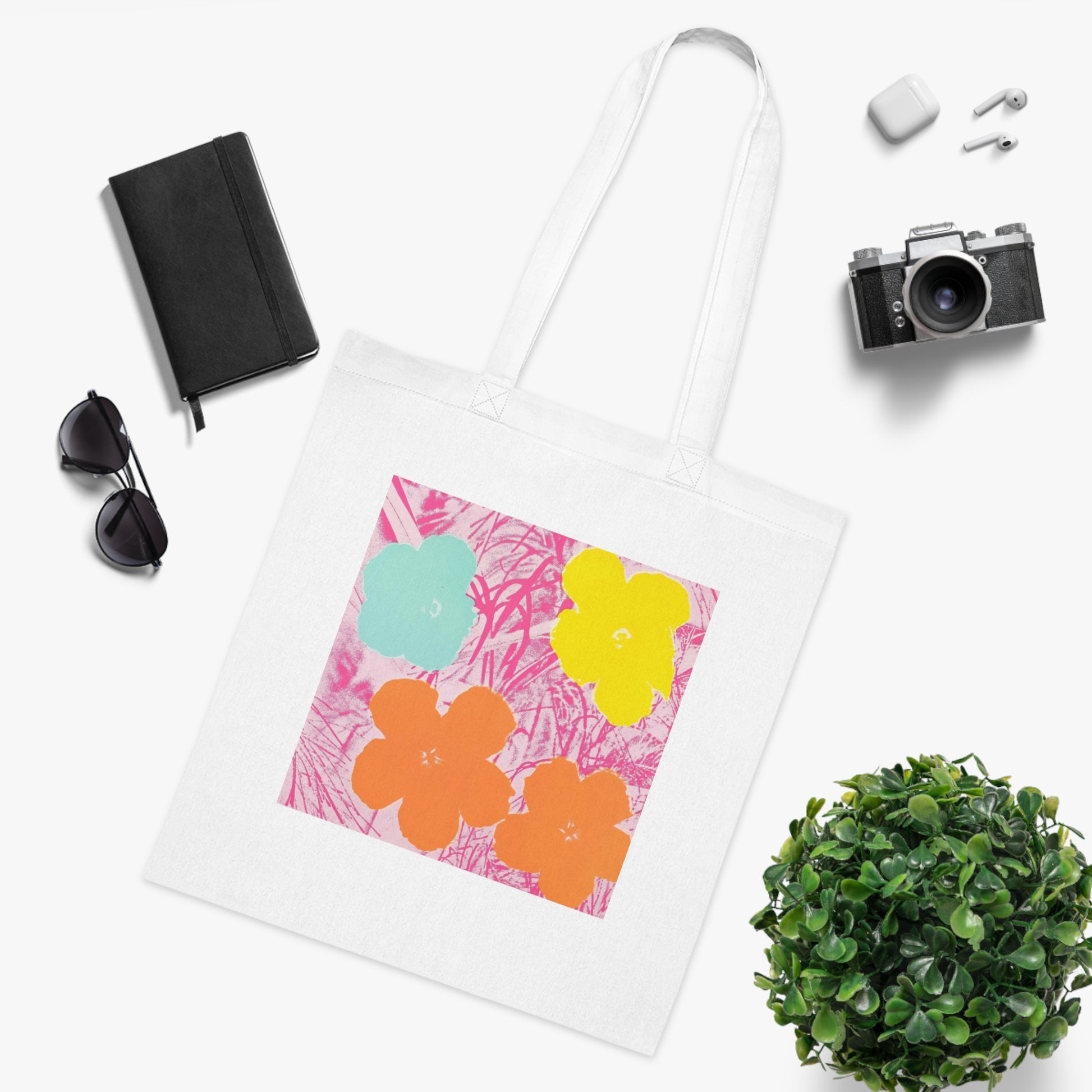 a tote bag sitting next to a potted plant