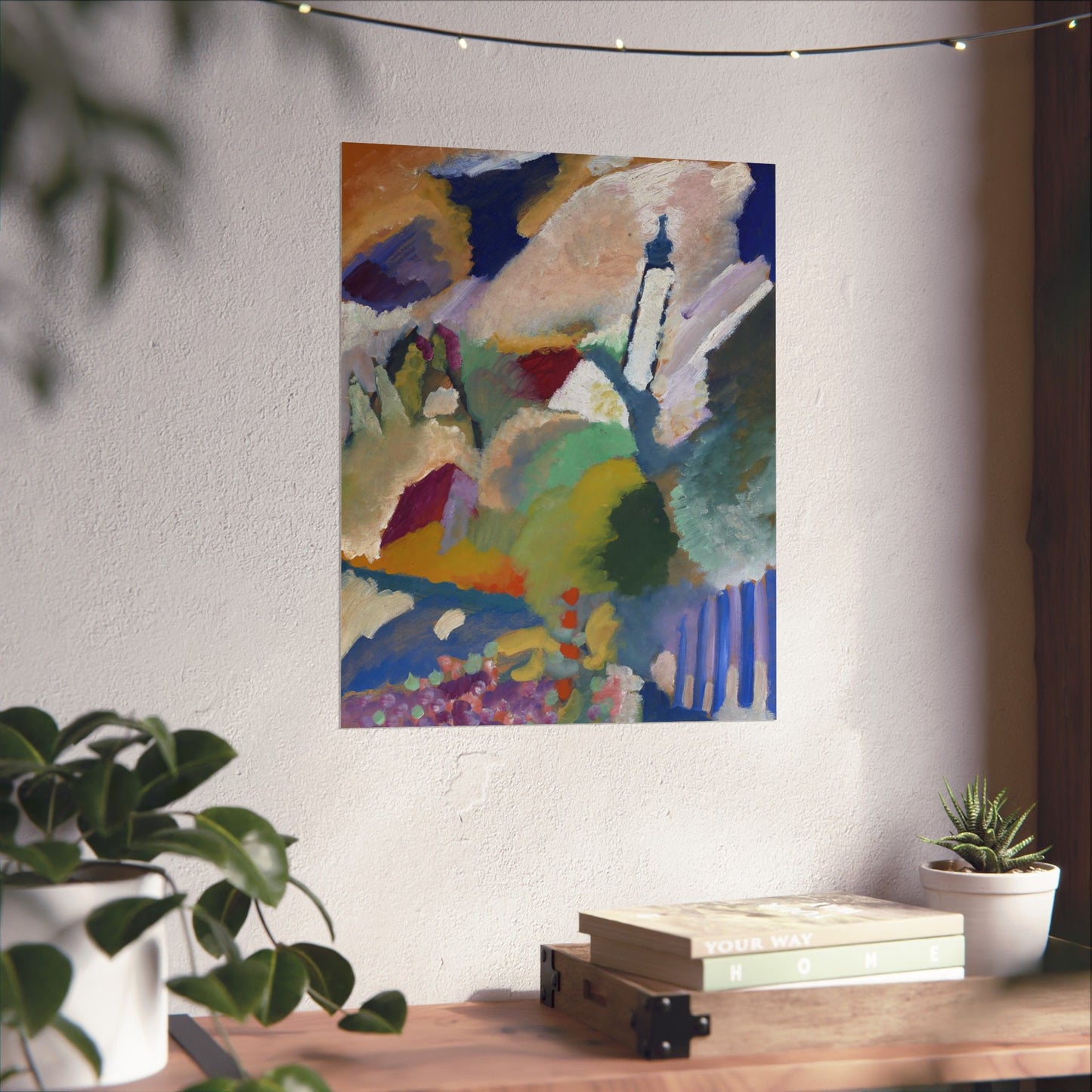 a painting hanging on a wall next to a potted plant