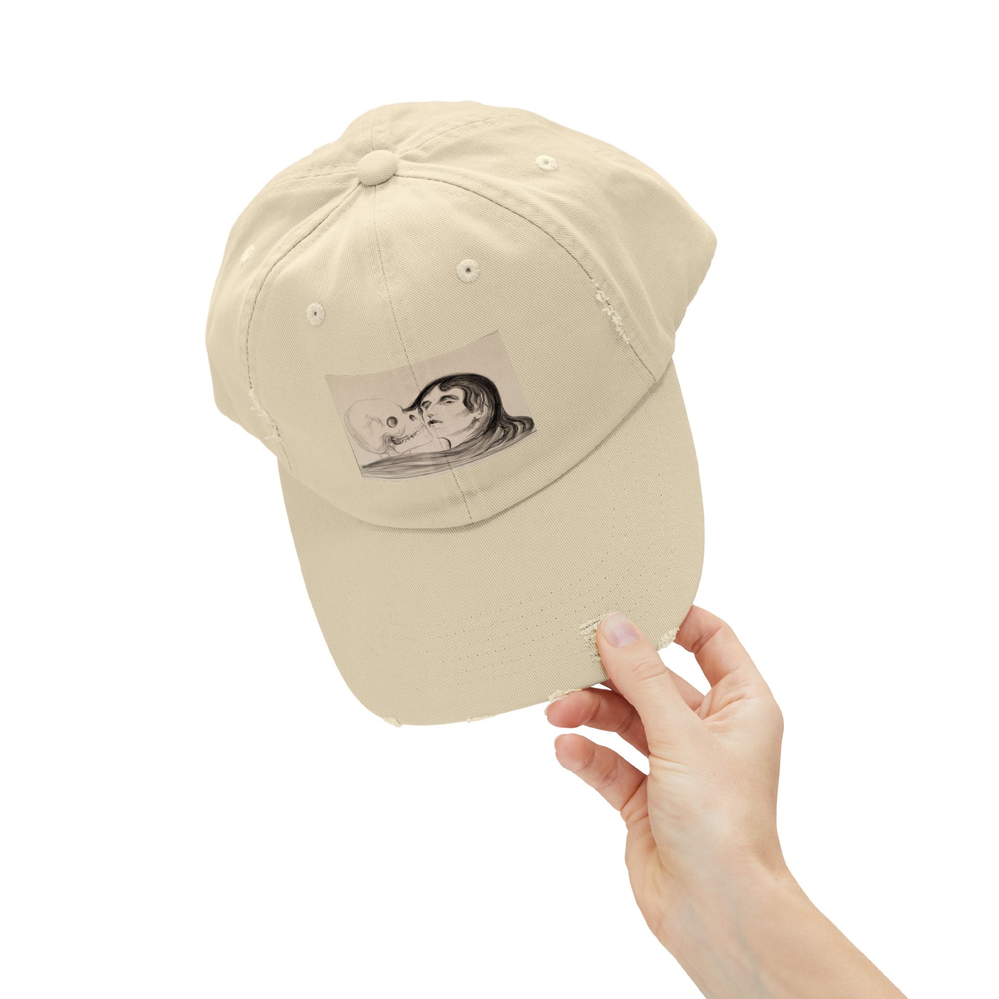 a hand holding a baseball cap with a picture of a woman on it