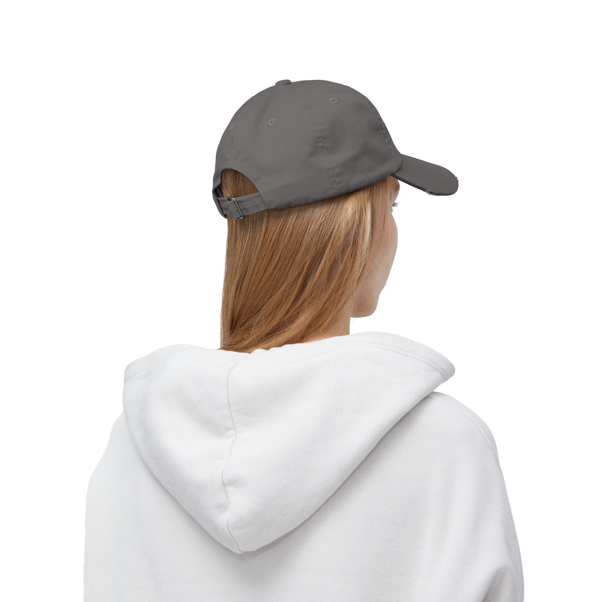 a woman wearing a white sweatshirt and a gray hat