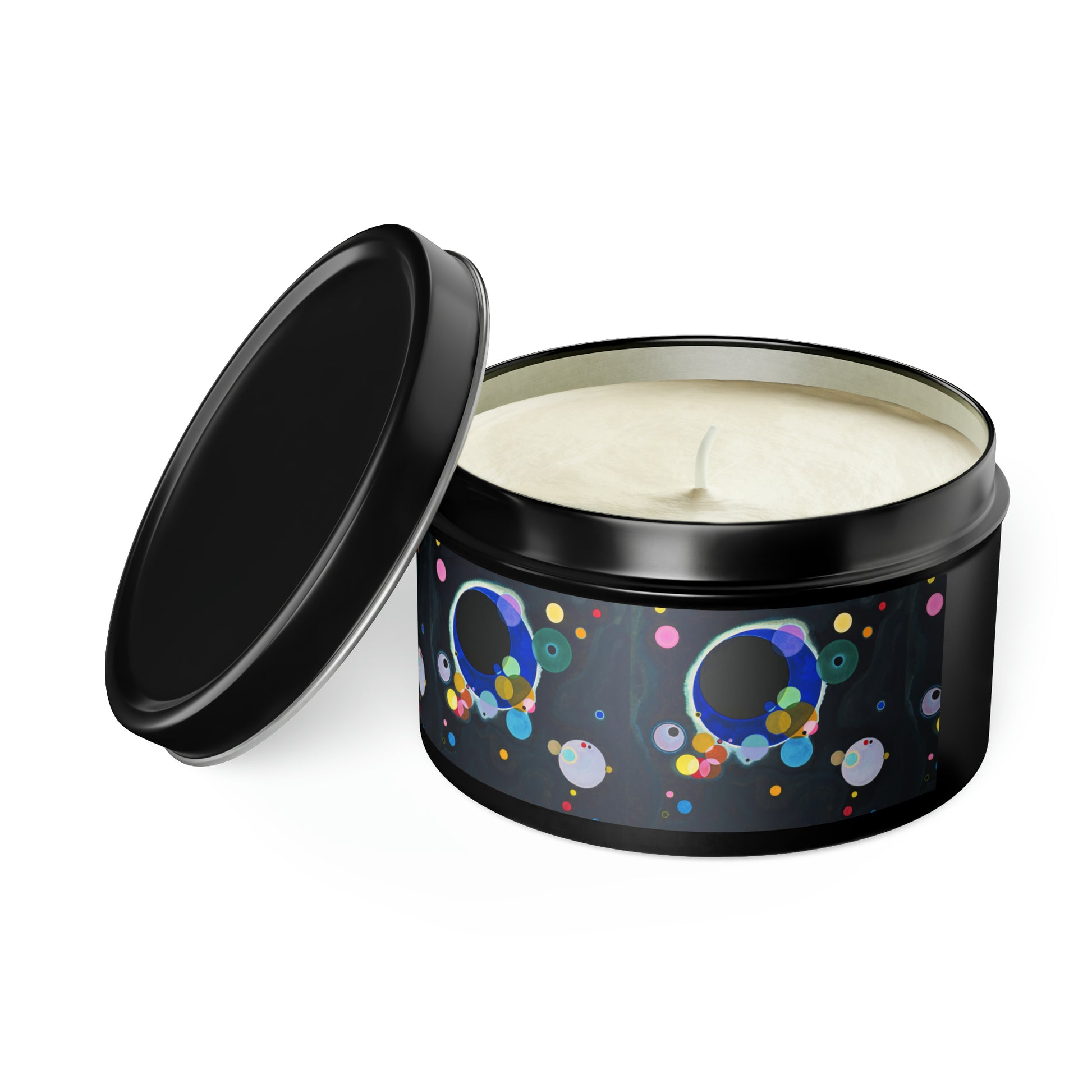 a black tin filled with a white candle