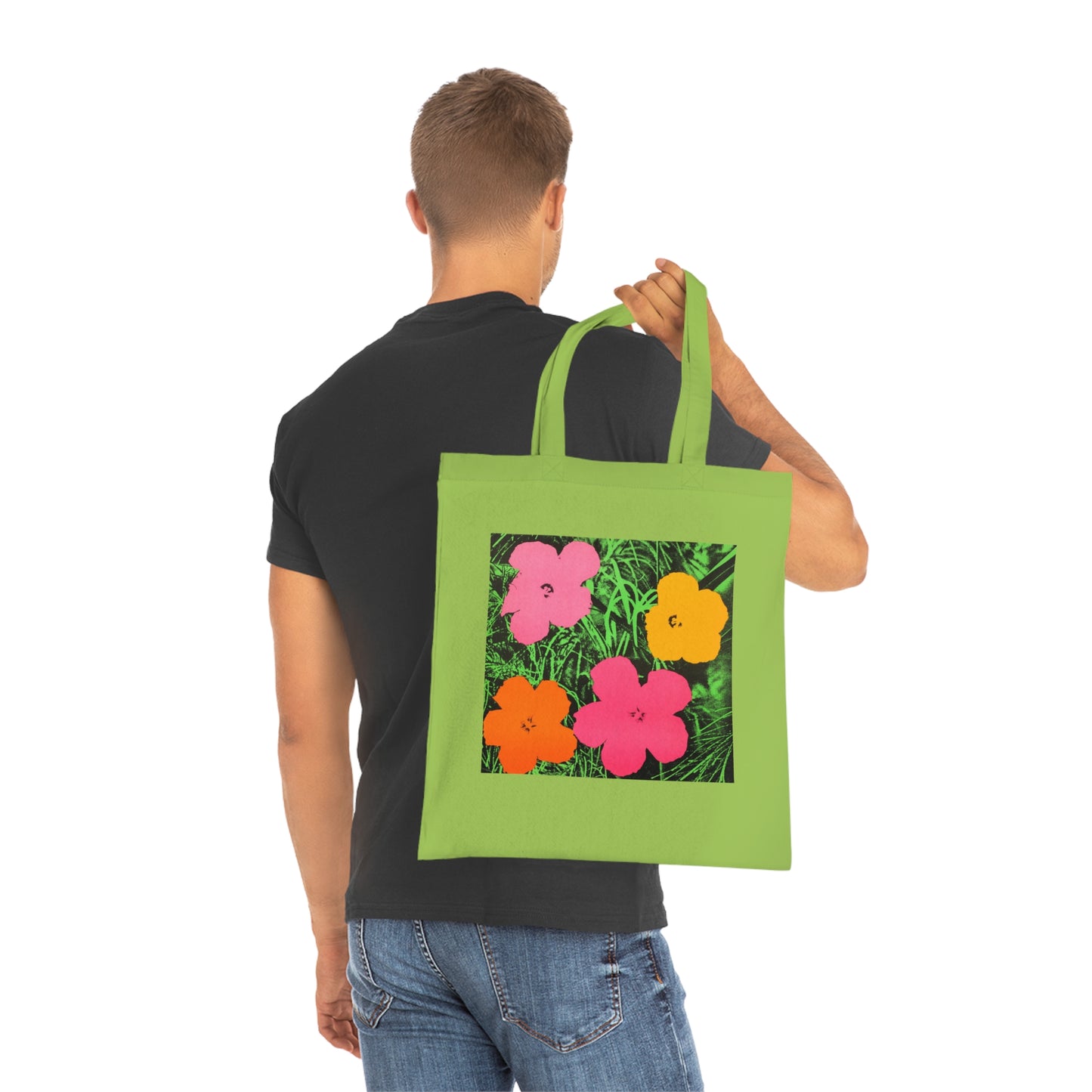 a man holding a green bag with flowers on it