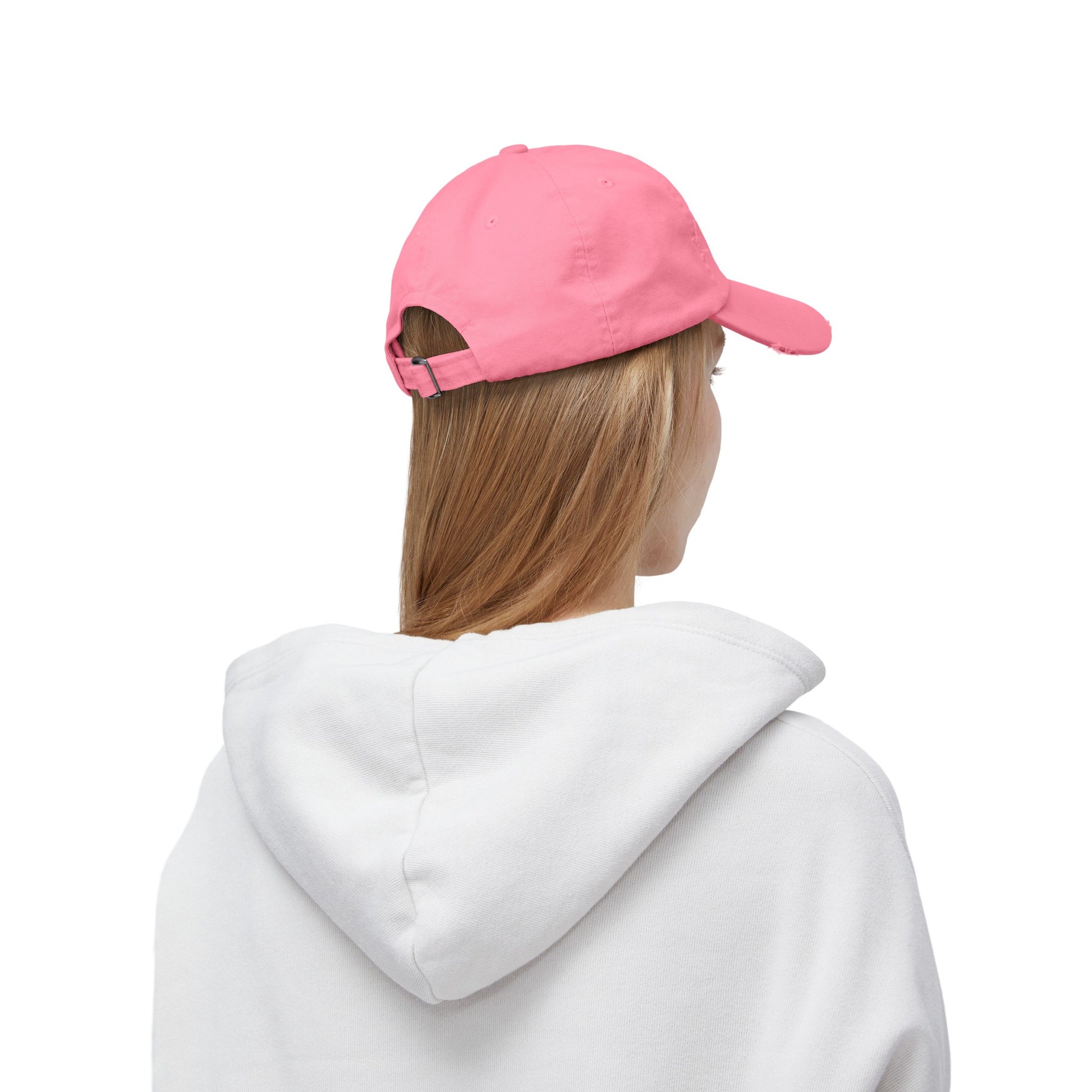 a woman wearing a pink hat and a white sweatshirt