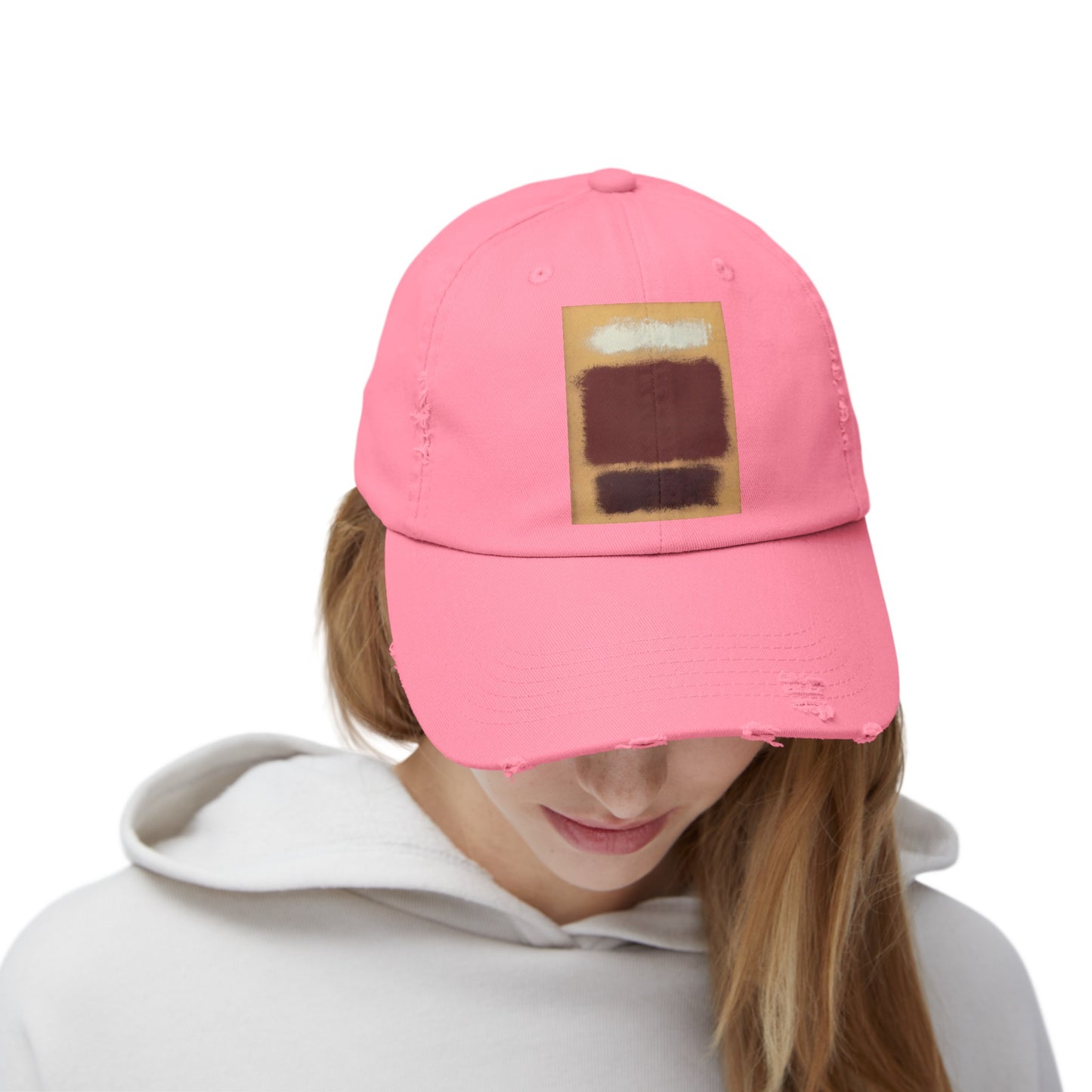 a woman wearing a pink hat with a patch on it