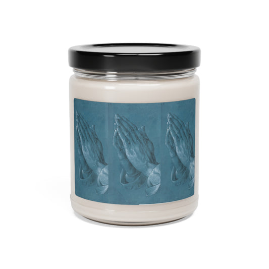 a candle with a picture of hands on it