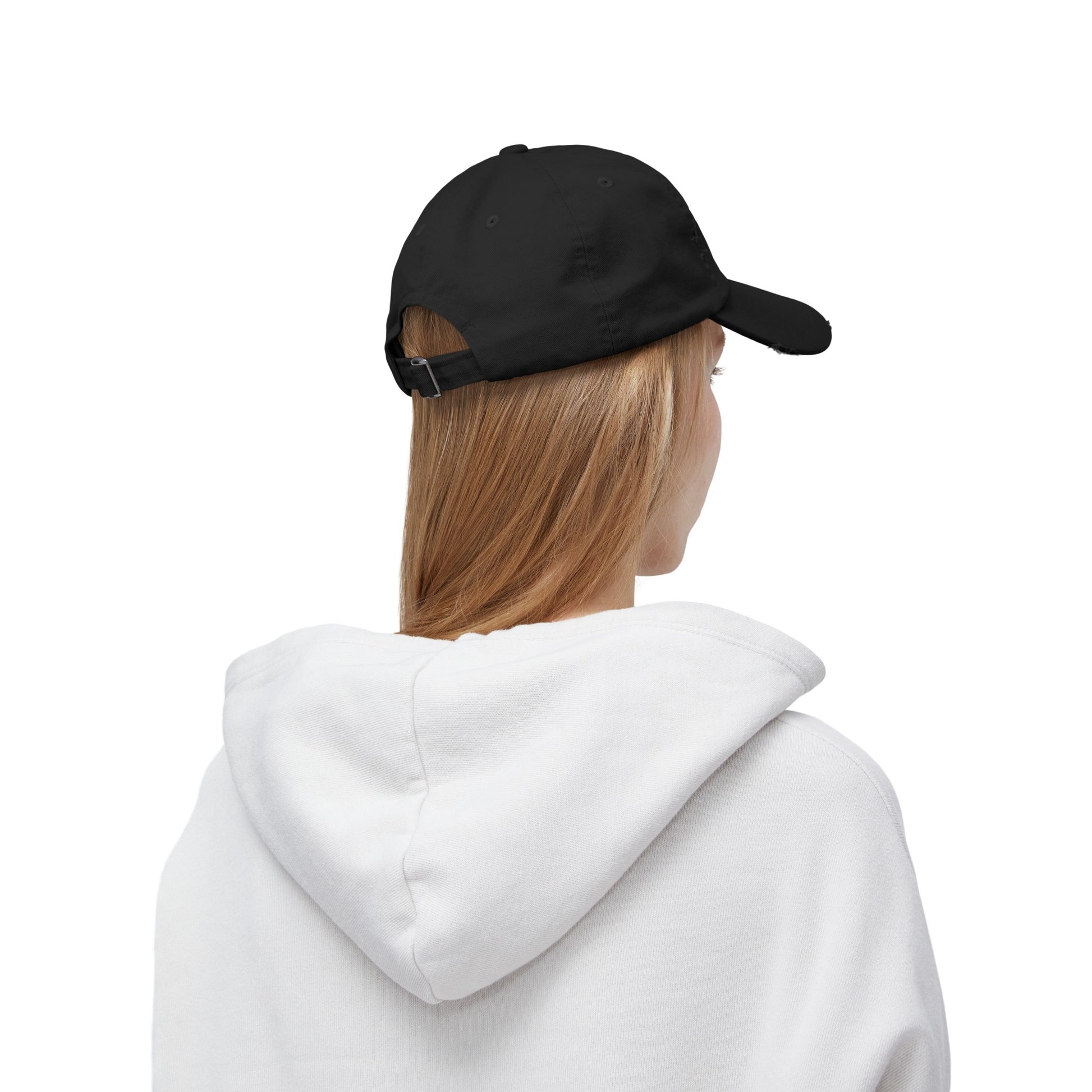 a woman wearing a white hoodie and a black hat
