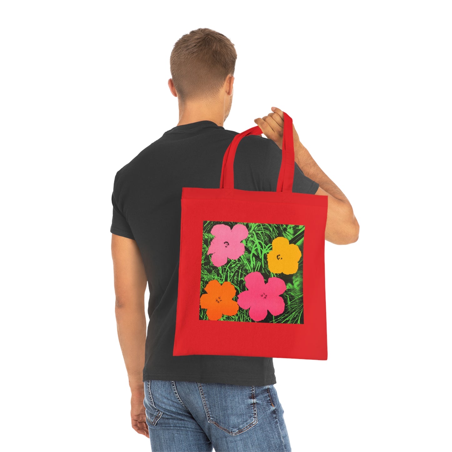 a man holding a red bag with flowers on it