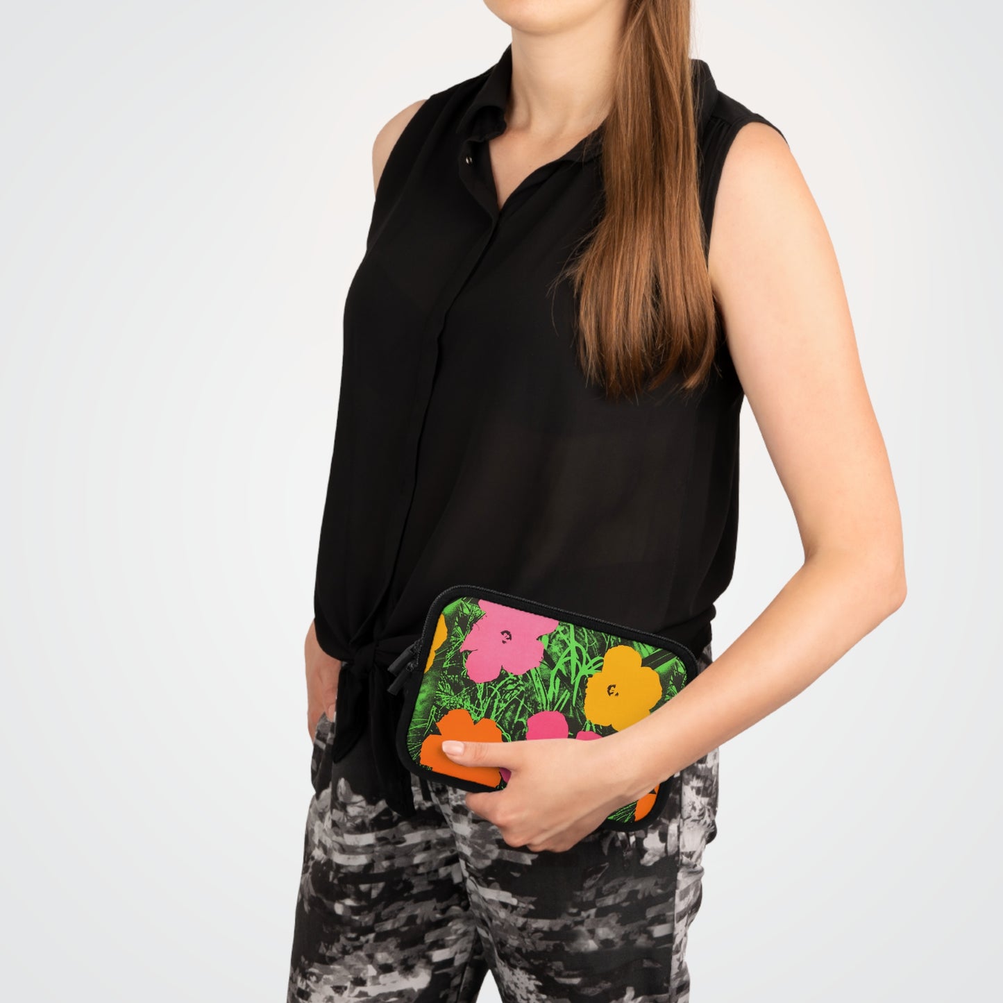 a woman in black shirt holding a colorful purse